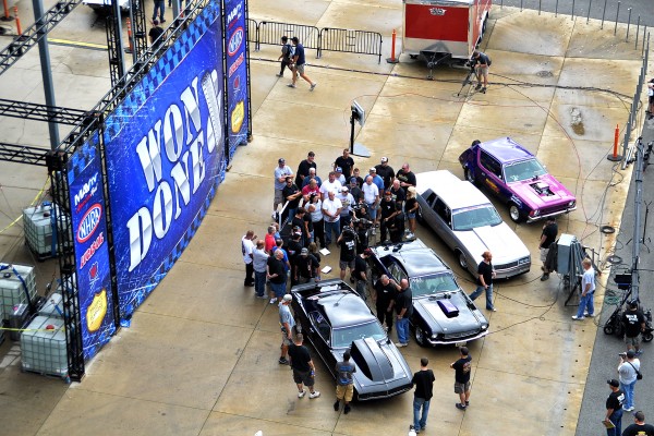 vintage muscle cars and drag racers in winner's circle