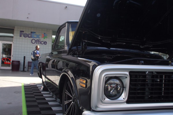 looking down the body line of a Customized Chevy C10 Squarebody lowrider pickup truck