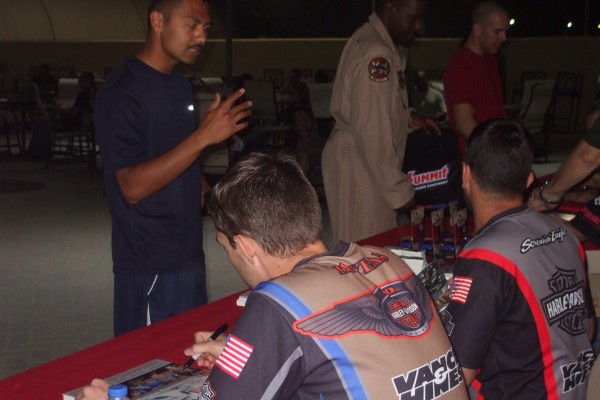 NHRA & Monster Truck Drivers signing autographs for troops stationed overseas