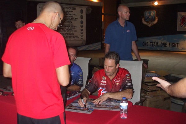 NHRA & Monster Truck Drivers signing autographs for troops stationed overseas
