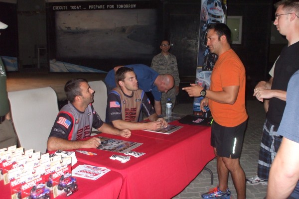 NHRA & Monster Truck Drivers signing autographs for troops stationed overseas