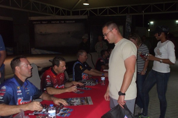 NHRA & Monster Truck Drivers signing autographs for troops stationed overseas