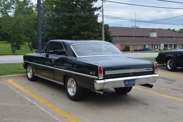 custom black 1967 Chevy II Nova with aftermarket wheels