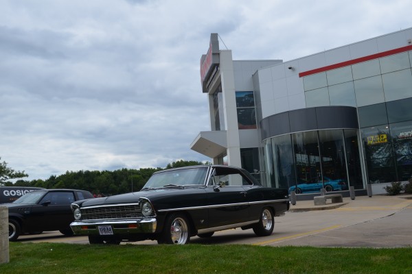 black 1967 Chevy II Nova with custom wheels parked at summit racing