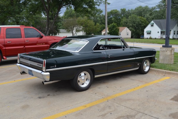 rear bumper view of a black 1967 Chevy II Nova with custom wheels
