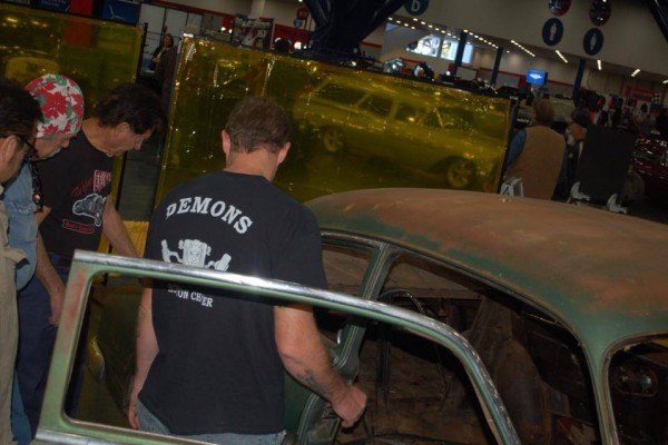 men working on building a custom hot rod