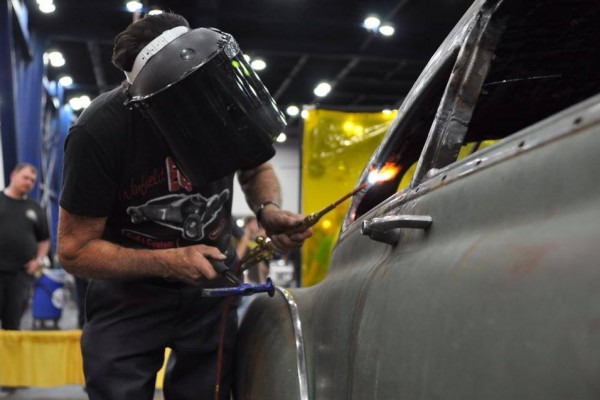 gene winfield using a torch on a hot rod window frame