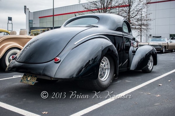 rear view of a black prewar ford hot rod with exaggerated fenders