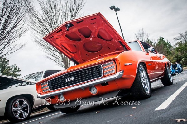 Front grille and headlight cover view of an orange 1969 camaro RS