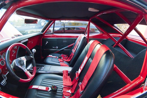 interior view of a custom vintage camaro with full race cage