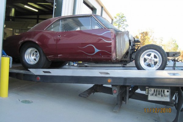 vintage Chevy 1967 camaro on flatbed trailer prior to restoration