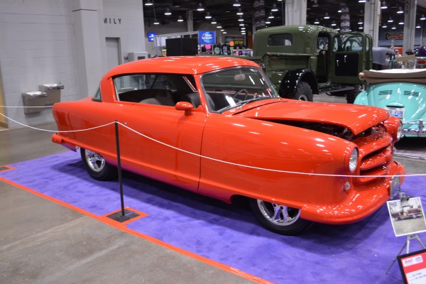 custom Nash metropolitan on display at indoor car show