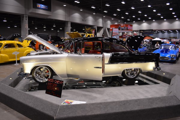 black and silver custom 1955 chevy displayed at indoor car show