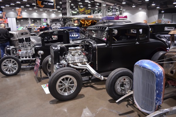row of classic v8 powered ford prewar hot rods displayed at indoor car show