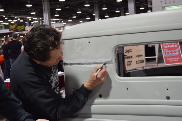 Gene Winfield marking a cut weld line on a hot rod body