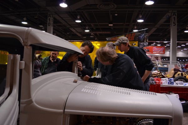Gene Winfield teaching hot rod metal shop work to onlookers
