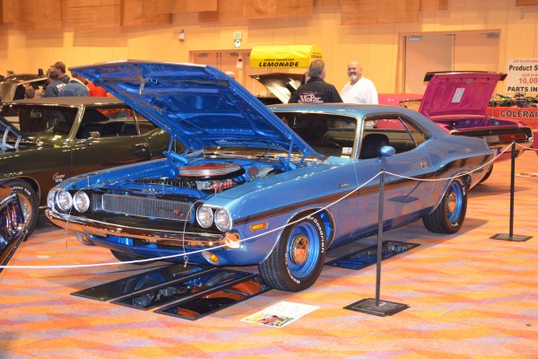 first gen blue dodge challenger R/T on display at indoor car show