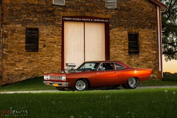 1968 Plymouth Roadrunner, side profile shot near barn