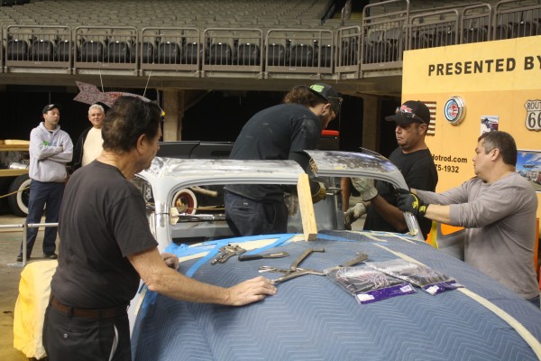 men chopping the roof or a car to make it a hot rod