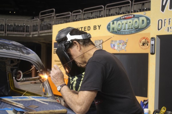 man welding seam on a chopped hot rod roof