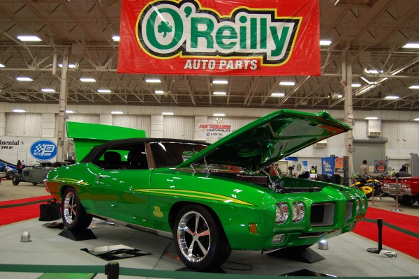 custom pontiac green judge convertible on display at indoor car show