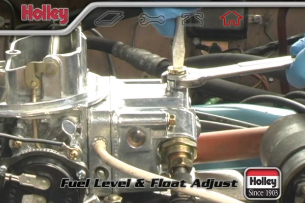 man adjusting jet on a holley carburetor