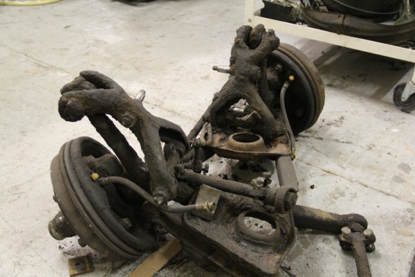 stack of rusty suspension parts removed from an old car