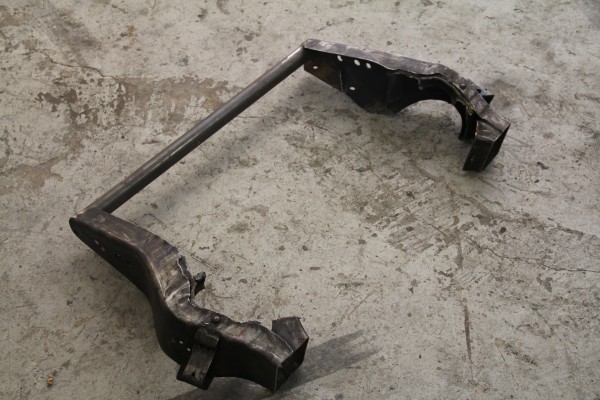 stock vehicle frame section removed and laying on ground