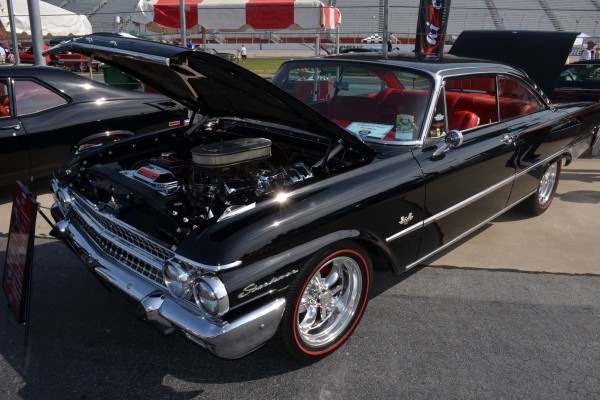 a vintage ford starliner coupe with custom wheels