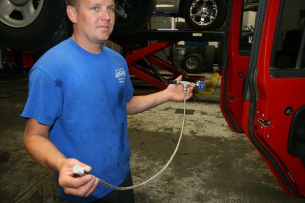 man holding oil pressure line for a gauge