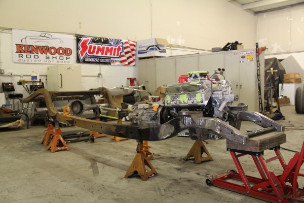 a hot rod chassis fitted with v8 engine during a build project