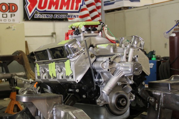v8 engine resting on bare frame of a hot rod project