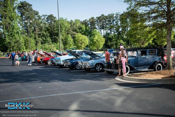 row of vintage cars and trucks at a classic car show