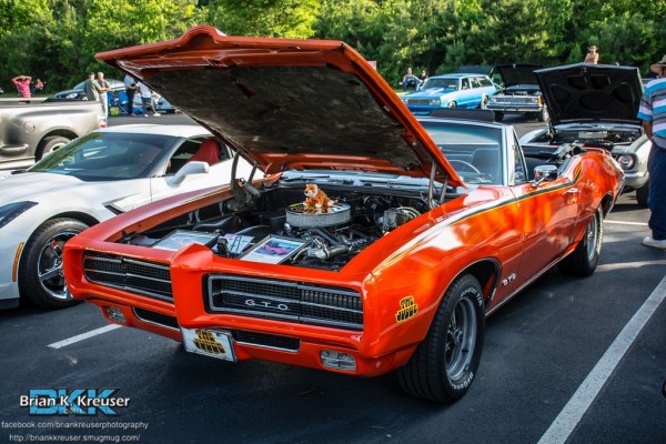 Orange pontiac GTO judge convertible with hood up