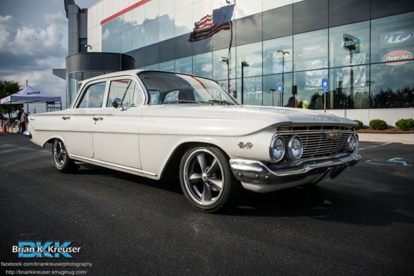 vintage 1960 chevy sedan coming into a car show
