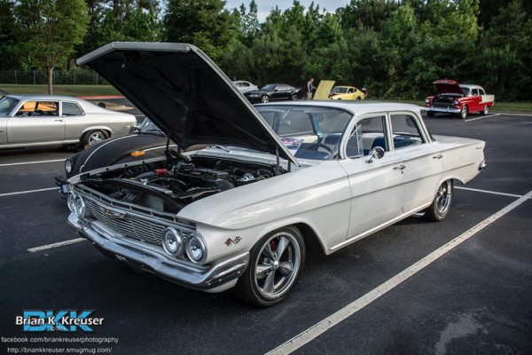 1960 white chevy sedan with custom wheels