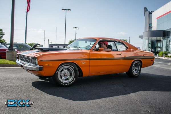 orange dodge demon pulling into summit racing store