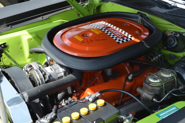 mopar 340 six barrel v8 engine in a classic muscle car
