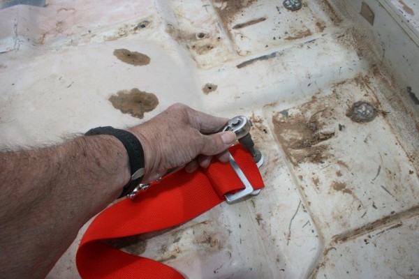 installing a racing harness mount on the floor of a jeep cj