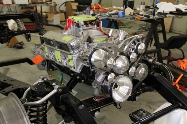 custom engine sitting in an old vehicle chassis during assembly