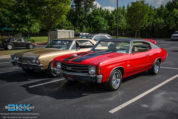 a pair of vintage chevy chevelles in a parking lot