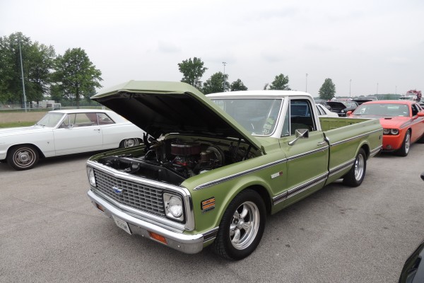 vintage green chevy pickup truck with chrome torq thrust wheels