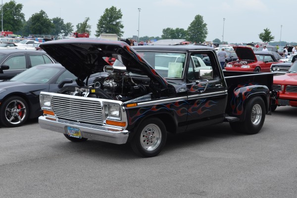hotrod ford pickup truck with flamed paint job and supercharged v8