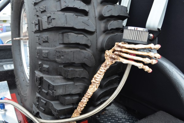 a skull holding a breather tube vent in a rat rod truck