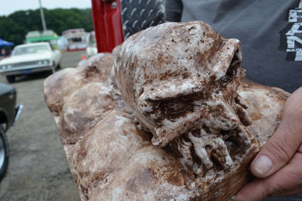 man holding a skull sculpture