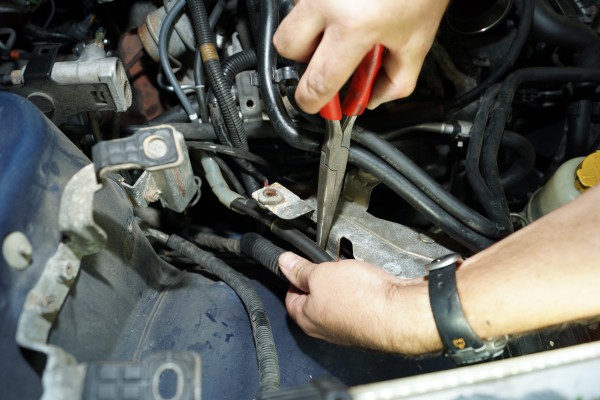 unclipping hoses and lines in an engine bay of a subaru wrx