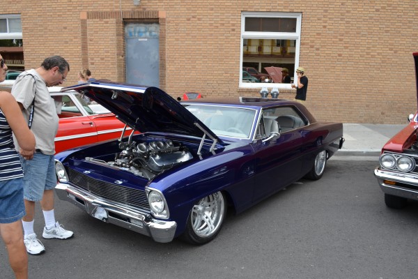 man looking at a chevy 2 nova street rod at 2014 Hot August Nights in Reno, NV