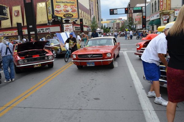 vintage mustang driving down main cruise alley at at hot august nights 2014