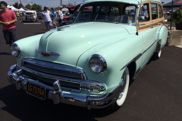 vintage chevy woody wagon on display at a car show