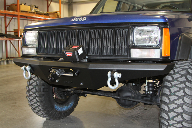 Front of a jeep Cherokee XJ with off-road bumper and winch installed